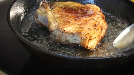 Raw pork chop in a frying pan
