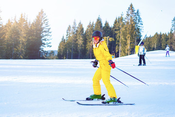 Girl with ski equipment is riding fast t in the mountain forest