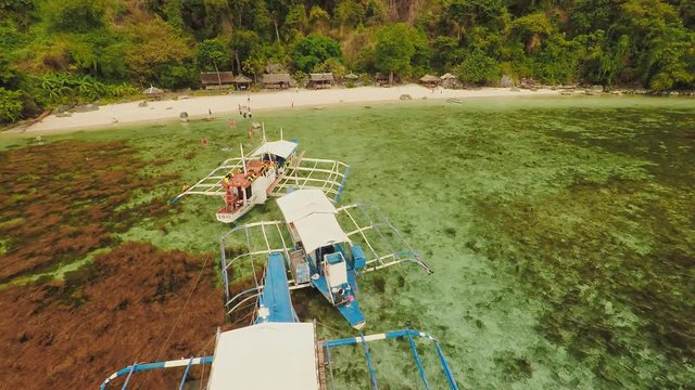 Aerial view Sunset and Atwayan beach with rocks and boats. Travelling tour in Asia: Palawan, Philippines.