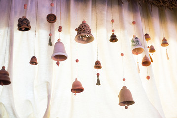 Original clay bells on a light background. Place for your text