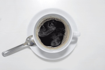 Soft focus of white coffee cup on white table