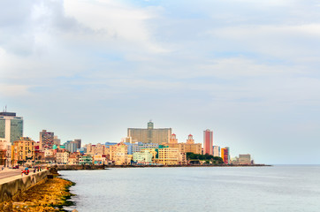 Obraz premium Multicolored buildings of Cuban Havana in the summer noon from the embankment near the ocean