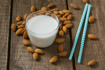 glass of almond milk on wooden surface