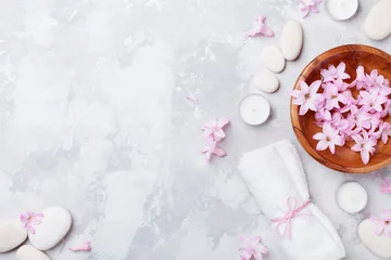 Tuinposter Aromatherapie, schoonheid, spa-achtergrond met massagekiezel, geparfumeerd bloemenwater en kaarsen op stenen tafelbladweergave. Ontspanning en zen-achtig concept. Plat leggen. © juliasudnitskaya