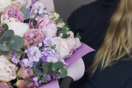 Fototapeta The big delicate bouquet of flowers in rustic style in woman hands