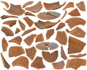 Various broken brown ceramic shards at various angles on white background