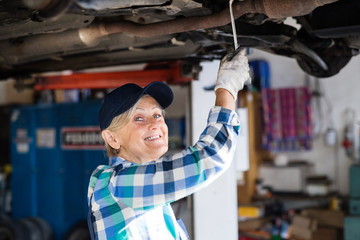 Portrait of a senior female mechanic in a garage.