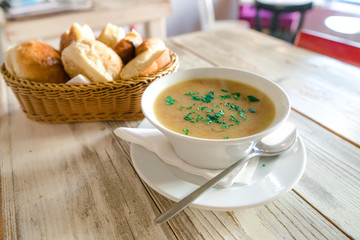 Delicious cream soup on plate with bread