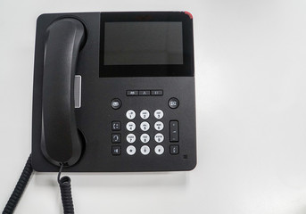 isolated modern IP phone on white table for communication in office