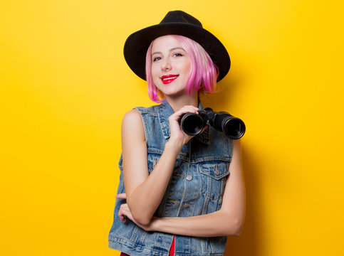 hipster girl with pink hair style with binoculars