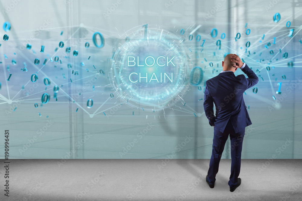 Poster businessman in front of a wall with blockchain title with 0 and 1 data flying over