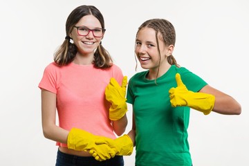 Two teen girls with yellow cleaning gloves shaking hands keep your finger up in white backgrounde