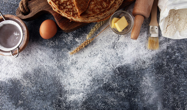 French crepes or pancakes with ingredient on grey background