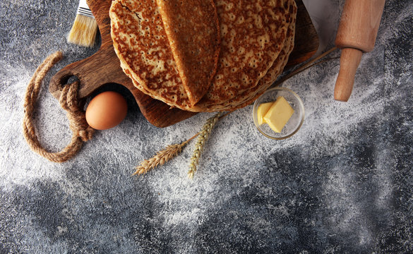 French crepes or pancakes with ingredient on grey background