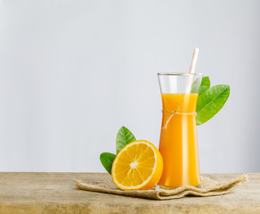Glass of fresh orange juice on wooden table, Fresh fruits Orange juice in glass with group of orange on white background, Selective focus on glass, isolate white background