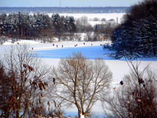 Tilt shift winter lake with fishermen      