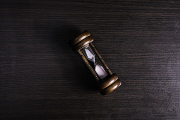 Hourglass on table background.