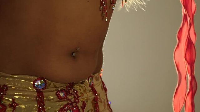 Torso of beautiful young arabian woman dancing oriental belly dance. slow motion