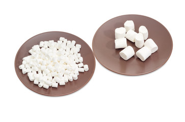 White marshmallow different sizes on two brown dishes