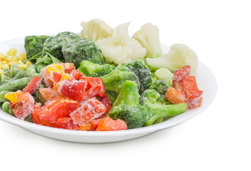 Various frozen vegetables on the white dish closeup