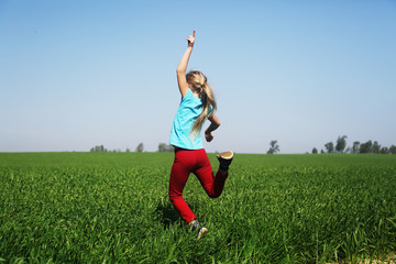 Cute girl jumping in the field