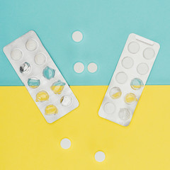 top view of medicines isolated on blue and yellow background
