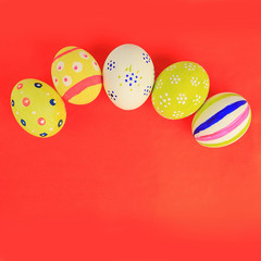 gift Easter eggs on a red background.the symbol of the holiday.