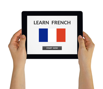 Hands holding digital tablet computer with learn French concept on screen. Isolated on white. All screen content is designed by me