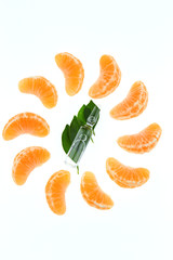 Vitamin C. Transparent  ampoule with vitamin C on mandarin leaves and slices of fresh manarin on a white background. Health and Beauty	