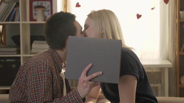 Two young cute lesbian girls hugging and passionately kissing and hiding behind a big gray book, cute, lovers, lgbt, girls, love, sex 60 fps