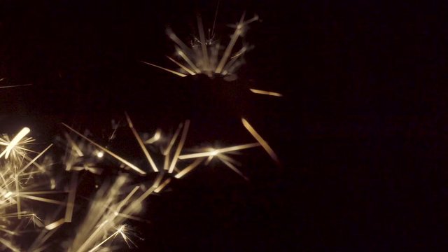 Firework sparkler burning on black background