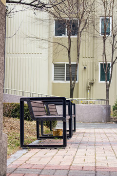 Side view on 2 benches in apartment complex