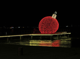 Giant glowing red Christmas ball outdoor in Larnaca, Cyprus