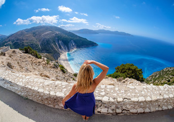 Beautiful young woman tourist looking at Myrtos Beach in Cephalonia Island Greece from above - 191011288