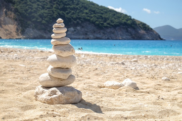 Fototapeta na wymiar Balancing several of stones on the seashore beach