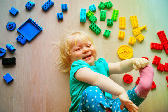 cute little baby girl love playing with plastic blocks