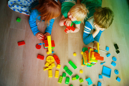 kids playing with plastic blocks, learning concept