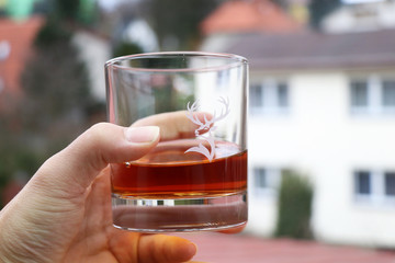 A glass full of ornaments of whiskey