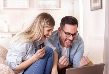 Young couple shopping online at home