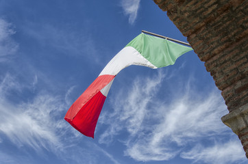 The Italian flag with clouds in the background