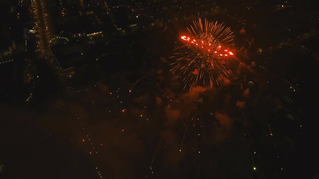 Aerial view Beautiful fireworks video from the drone in the night sky on celebration. Sparks. Fireworks are a class of explosive pyrotechnic devices used for aesthetic and entertainment purposes