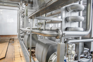 Stainless steel pipes in the factory. Construction on food production, Abstract industry background.
