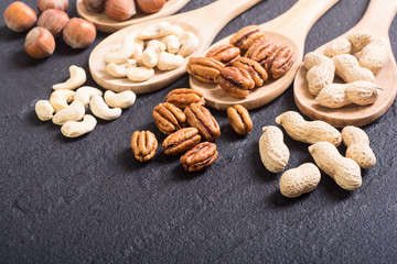 Mix of nuts in wooden spoon