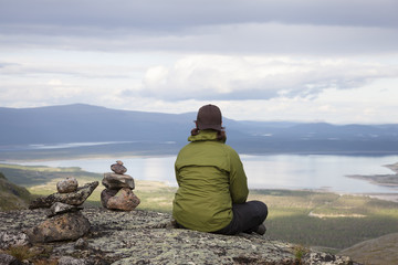 Hiker gazing over a mountain lake