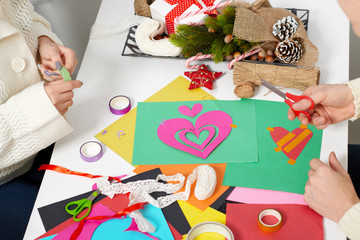 young couple making hearts from paper for Valentine day, top view - romantic and love concept