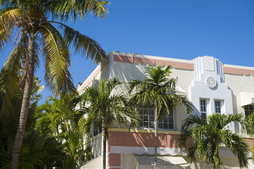 Fototapeta na wymiar Close-up detail of typical colorful 1930s Art Deco architecture with palm tree in Miami, Florida