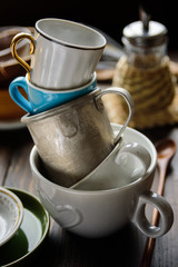 Stack of old different cups and mugs