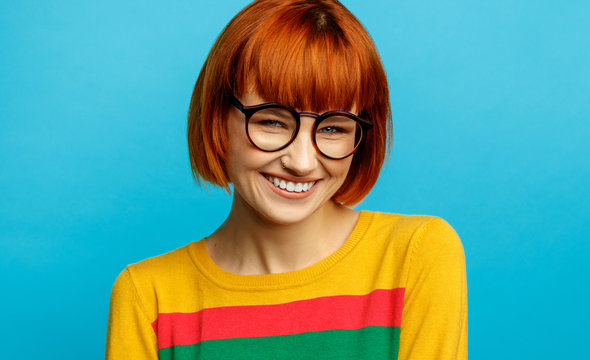 Portrait Of Beautiful Smiling Woman With Red Hair And Glasses