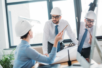 professional architects working with building plan at office