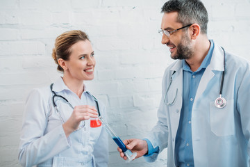 male and female doctors with laboratory flasks